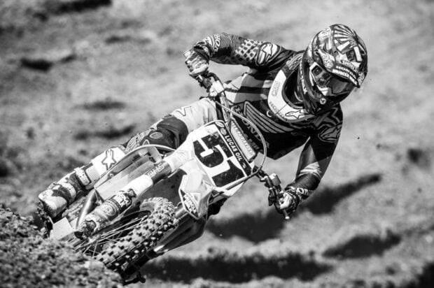 A motocross rider navigates a dirt track with high speed and skill on his bike, HD Desktop Wallpaper