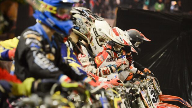 Motocross riders are lined up wearing helmets and gear ready to race their bikes, 2K Desktop Wallpaper