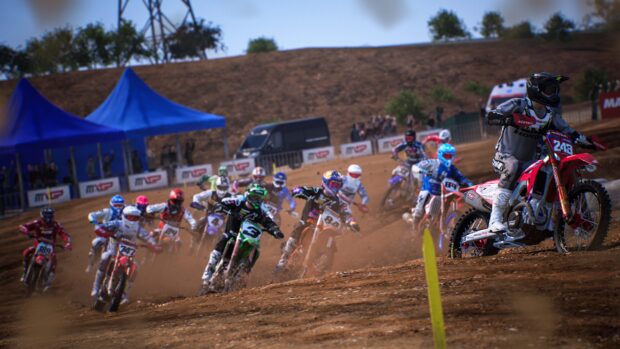 Several motocross riders compete in a fast paced race on a dusty dirt track, 4K Desktop Wallpaper