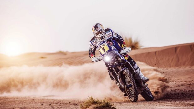 A motocross racer rides through desert dunes kicking up dust, 4K Desktop Wallpaper
