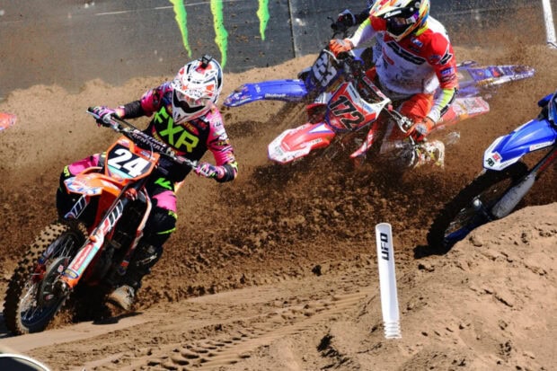 Two motocross riders compete on a dusty dirt race track, HD Desktop Wallpaper