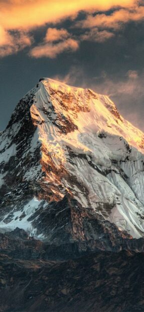 Snowcapped Mount Everest during sunset with dramatic clouds in the sky