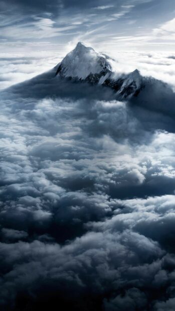 Mount Everest rises majestically above thick clouds in a breathtaking high altitude view