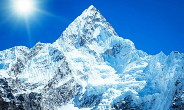 A stunning view of Mount Everest covered in snow under a bright clear sky