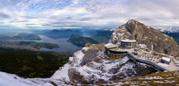 A panoramic view of Mount Pilatus with snow covered peaks and lake Pilatus scenery