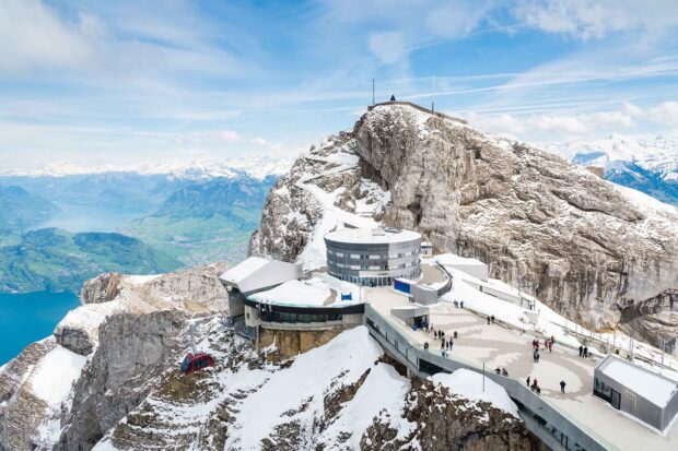 Snow covered Mount Pilatus with cable car and visitors on a clear day in the Swiss Alps
