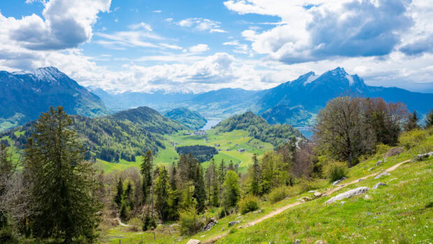 Beautiful green landscape with Mount Pilatus and surrounding hills under a blue sky