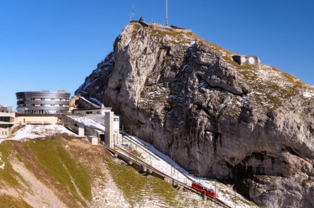 Snow covered mountain with a funicular railway climbing Mount Pilatus in clear weather
