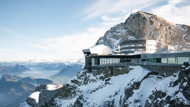 Cable car station on snowy Mount Pilatus with panoramic mountain views