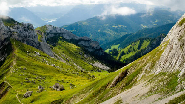 Green mountain slopes and rocky cliffs forming Mount Pilatus valley view