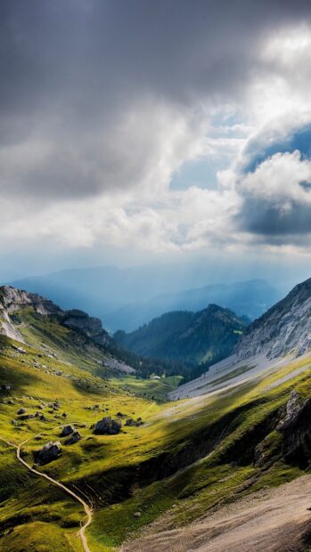 Scenic mountain landscape with green valleys and cloudy skies at Mount Pilatus