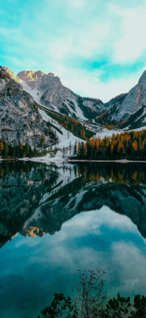 A tranquil mountain lake reflects rocky peaks and autumn trees on a clear day, HD Mobile Wallpaper