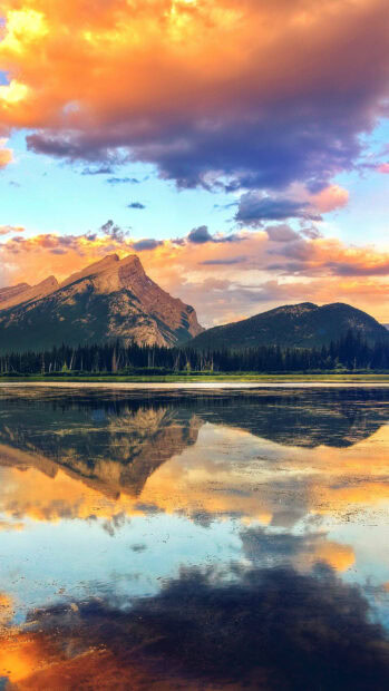 The mountain lake reflects the colorful sunset sky and surrounding forest, HD Mobile Wallpaper