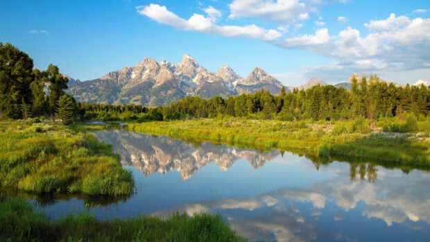 A scenic view of mountains and forest reflected in calm river under a blue sky, 4K Desktop Wallpaper