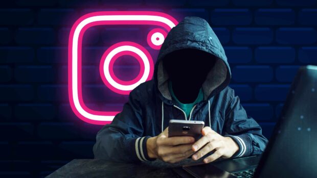 A person in a hooded jacket is using a phone with the Instagram logo glowing in the background, 2K Desktop Wallpaper