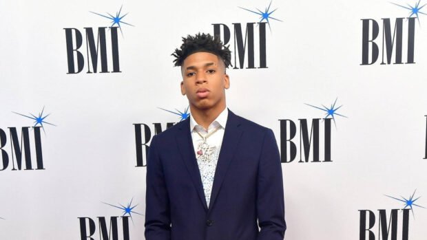 Nle Choppa standing in a suit at a BMI event wearing a chain necklace