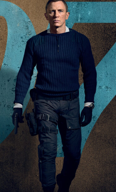 A man in tactical gear holding a gun stands against a textured wall, HD Mobile Wallpaper