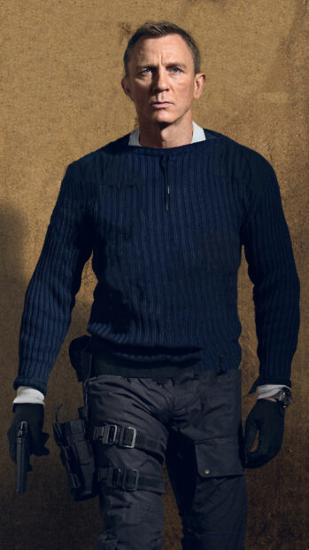 A serious man holding a gun and dressed in tactical gear in No Time To Die, 2K Mobile Wallpaper