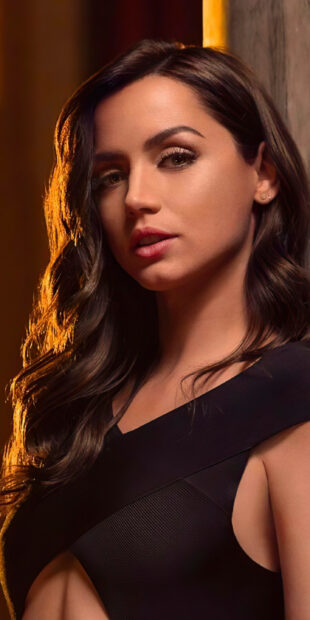 A close up portrait of a woman with soft lighting and dark hair in No Time To Die, 2K Phone Wallpaper