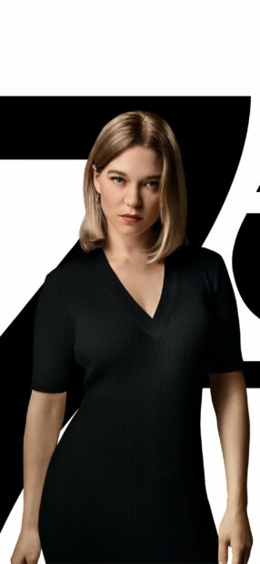 A woman stands confidently wearing a black dress from No Time To Die, 2K Phone Wallpaper
