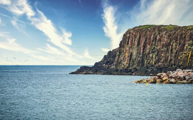 The sea meets the rugged cliffs under a blue sky in Northern Ireland, HD Desktop Wallpaper