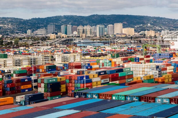 Oakland Wallpaper 2K Desktop the view of colorful shipping containers at a busy port with oakland city skyline in the background