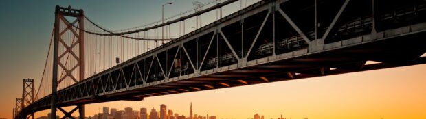 Oakland Wallpaper 4K Desktop city skyline of Oakland seen beneath the large suspension bridge at sunset