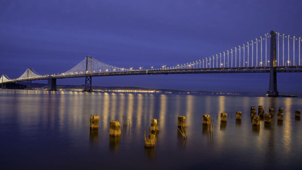 Oakland Wallpaper HD Desktop Bridge lights reflecting on water at night in Oakland cityscape