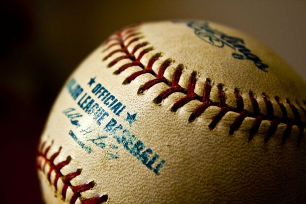 A detailed close up of an official Major League Baseball with visible stitches, HD Desktop Wallpaper