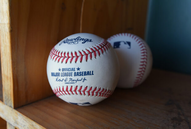 A close up of an official Major League Baseball on a wooden shelf with another ball in the background, HD Desktop Wallpaper