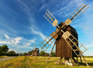Traditional windmills standing along the scenic landscape in Oland Sweden