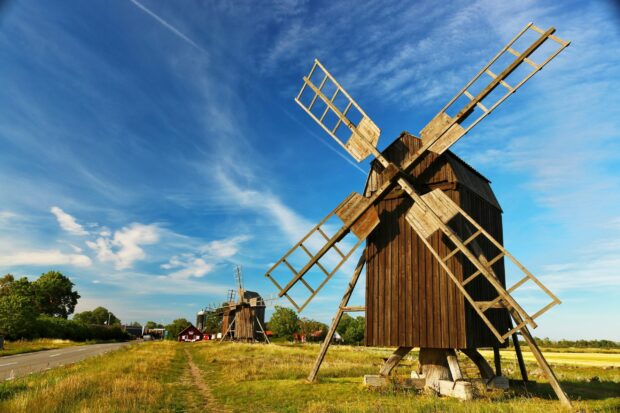 Traditional windmills standing along the scenic landscape in Oland Sweden