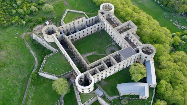 Aerial view of historic fortress ruins surrounded by green landscape in Oland Sweden
