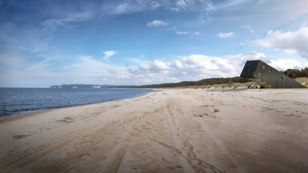 A sandy beach in Oland Sweden with modern black minimalist building and cloudy blue sky