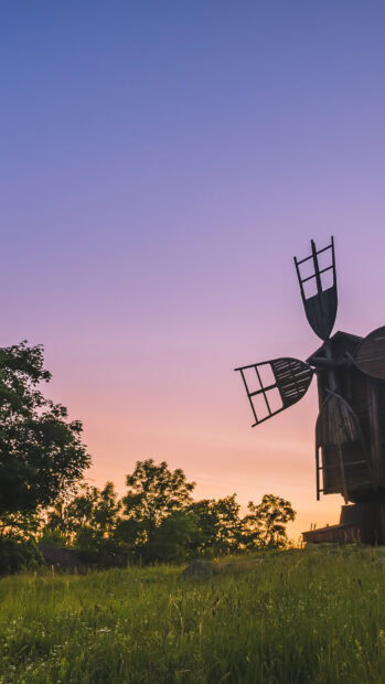 Traditional Oland windmill stands tall against a colorful sunset sky