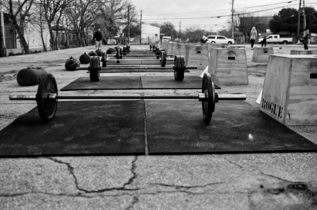 Boxes, and mats, A Crossfit training area with barbells and wooden boxes set outdoors for a workout session, 2K Desktop Wallpaper