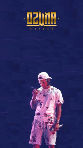 A young man wearing floral clothes and a cap holds a microphone and phone under blue lights in Ozuna Wallpapers