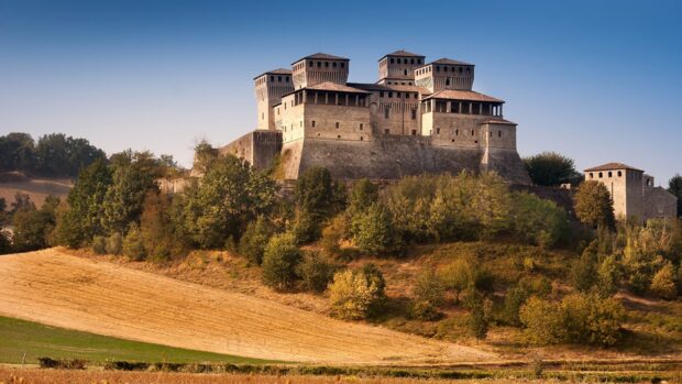 Medieval fortress in Parma Italy surrounded by lush greenery and fields
