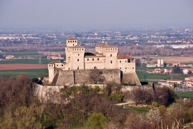 A historic fortress stands prominently in the countryside of Parma Italy