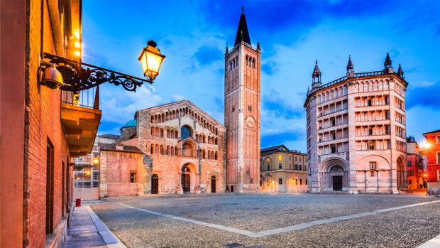 Historic square and medieval buildings in Parma Italy during sunset