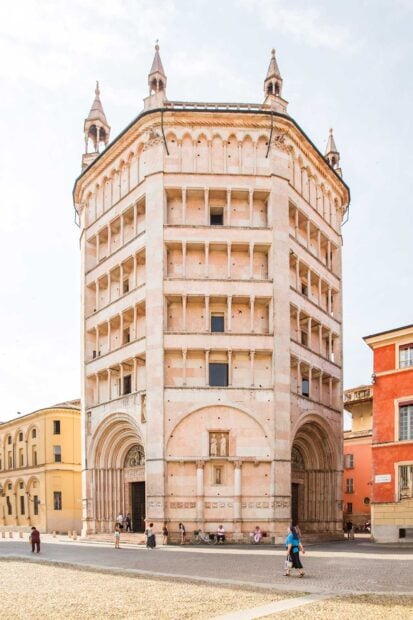 Historic Parma Italy architecture with tourists standing outside the building