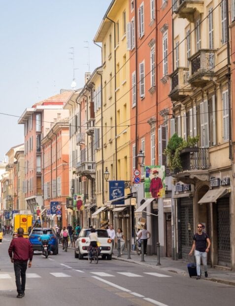 Street view of Parma Italy with colorful buildings and people walking and cycling