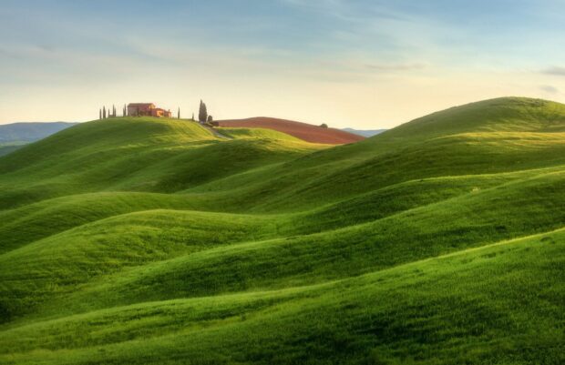 The green hills wallpapers show rolling grassy hills with a house on top under a soft sky, HD Desktop Wallpaper