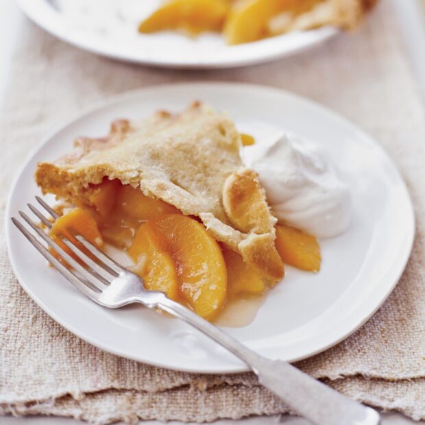A slice of pie with juicy peach filling and whipped cream on a white plate, HD Desktop Wallpaper
