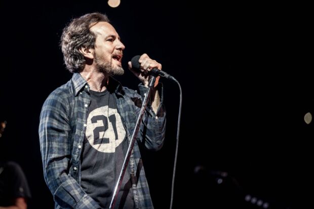 The Pearl Jam lead singer passionately sings into a microphone during a concert, HD Desktop Wallpaper