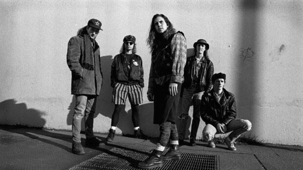 Pearl Jam band members standing and crouching outdoors in black and white photo, HD Desktop Wallpaper