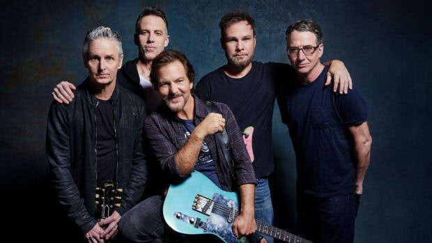Pearl Jam Wallpapers featuring the band members posing with a guitar and dark background, HD Desktop Wallpaper