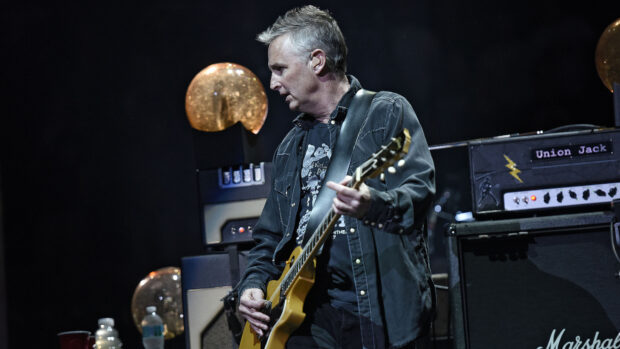 A Pearl Jam guitarist performs on stage with a guitar and amps, HD Desktop Wallpaper