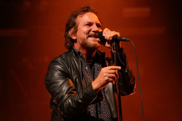 The Pearl Jam lead singer is passionately singing into a microphone on stage, HD Desktop Wallpaper