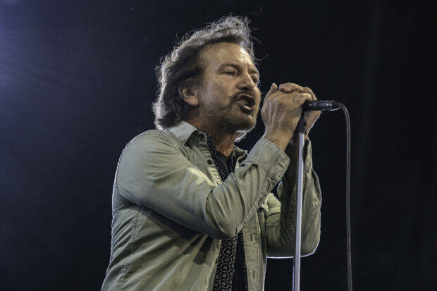 The lead singer passionately sings on stage during a Pearl Jam concert, HD Desktop Wallpaper